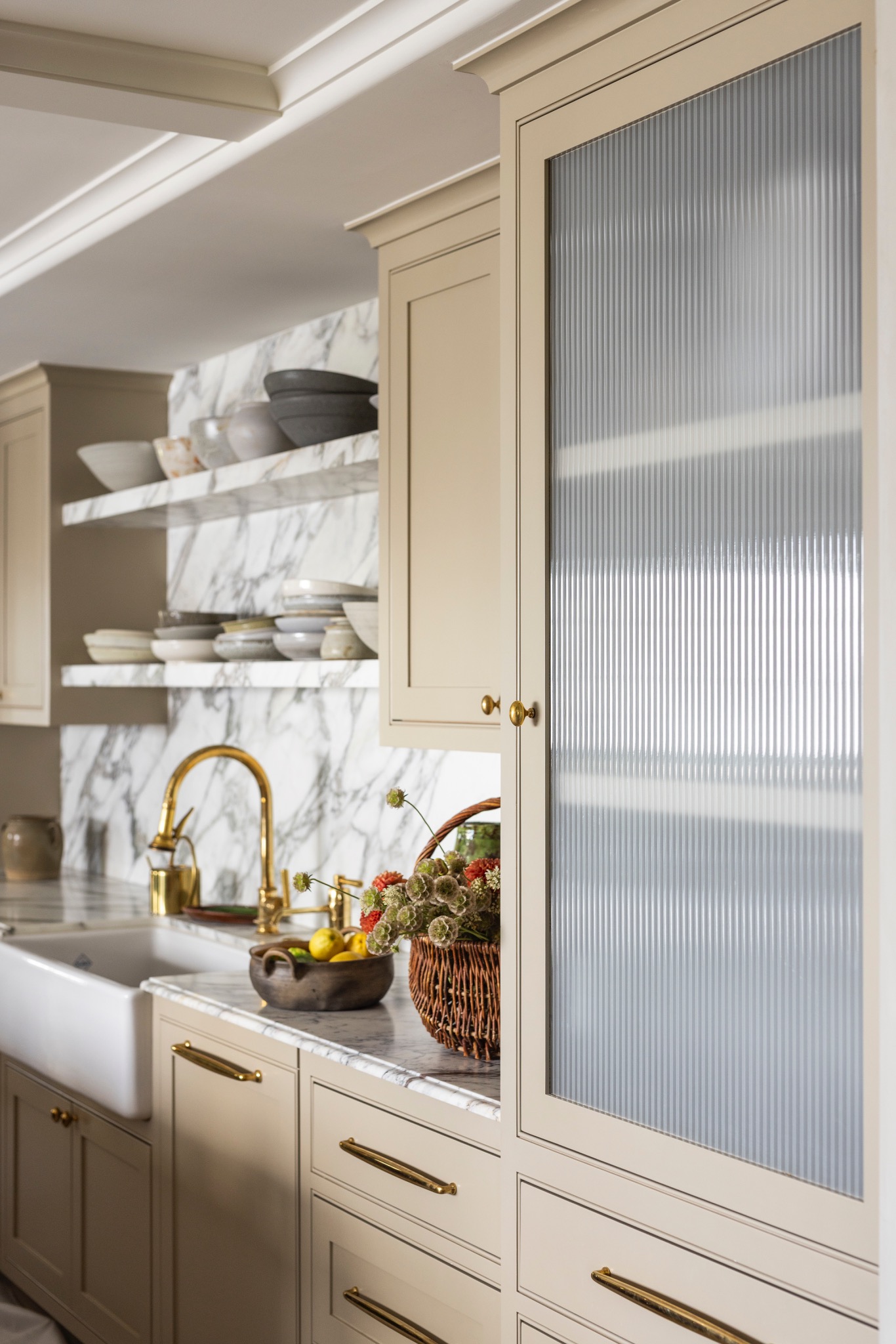 Marble shelving, painted cabinetry and reeded glass beside the Adobe Canyon kitchen sink